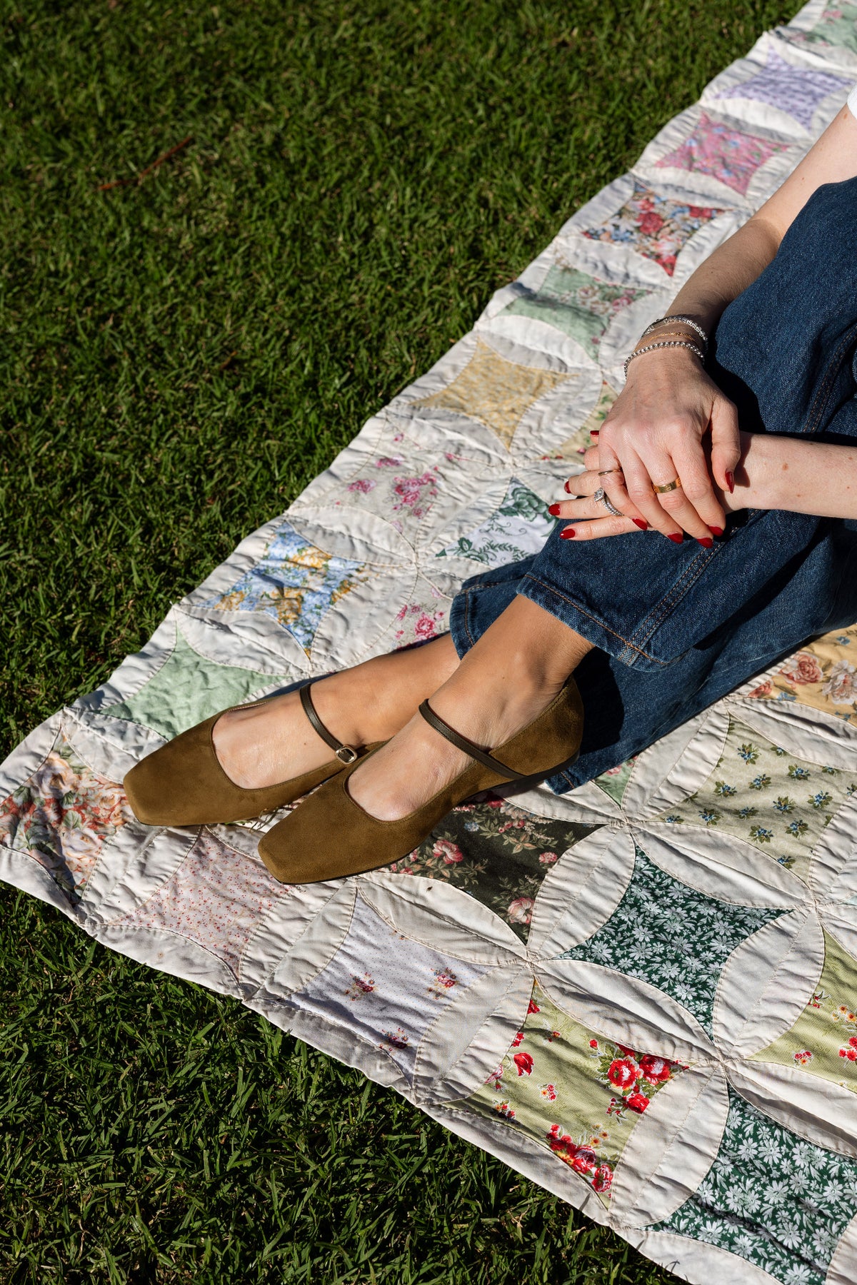 Pretty Ballerinas olive Mary Janes on a picnic blanket
